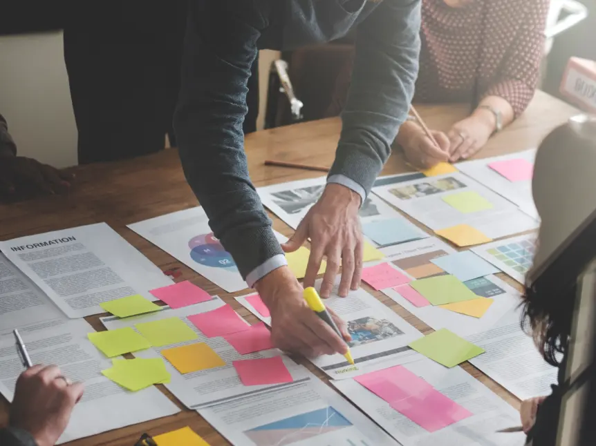 Education leaders analysing documents and mapping pressure patterns during resilience literacy workshop.